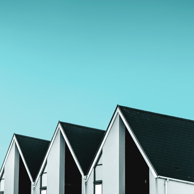 Townhomes roofline with a blue sky