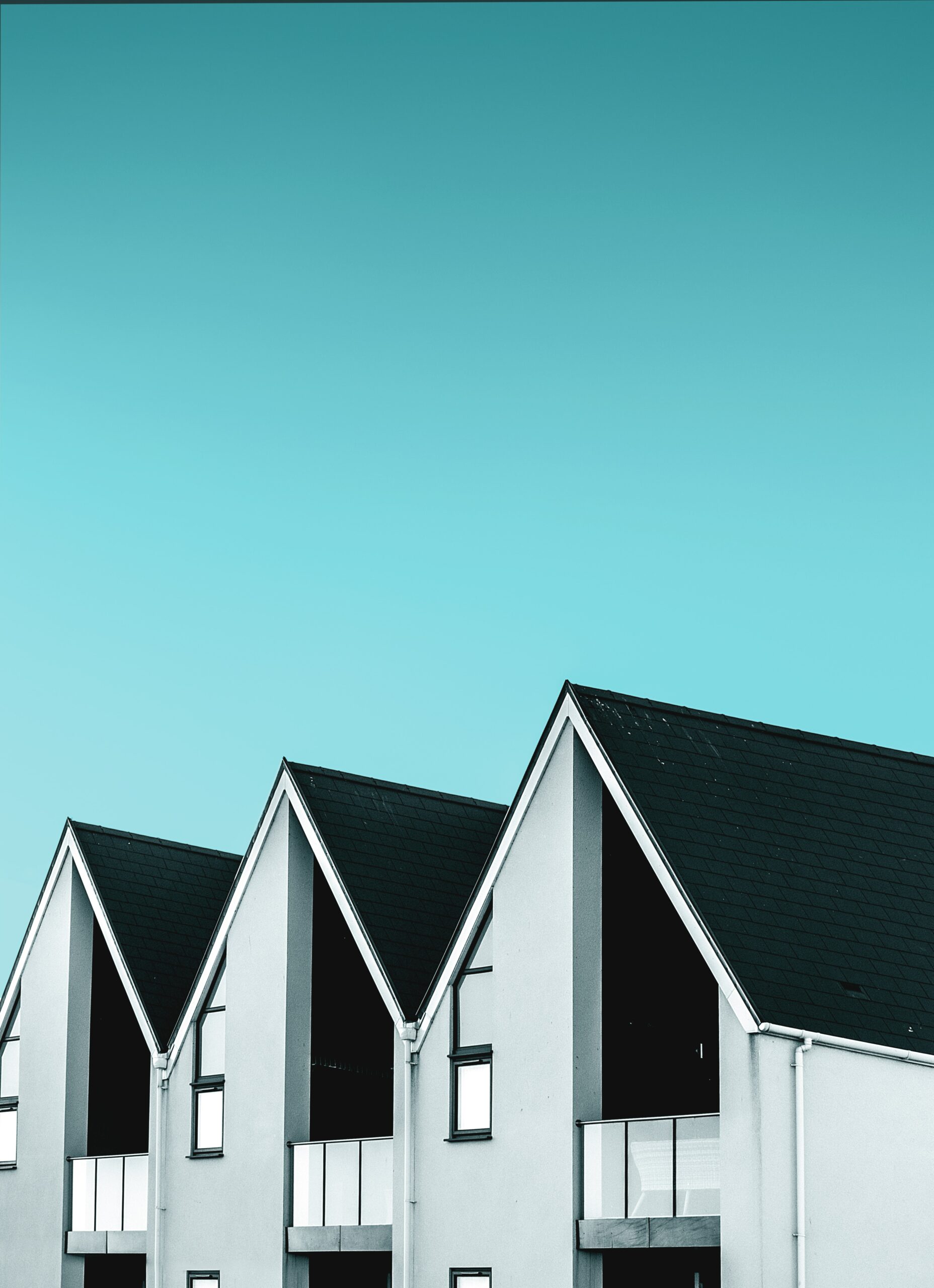 Townhomes roofline with a blue sky